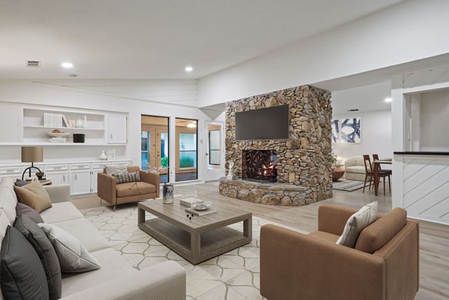 Virtually Staged Family room with a stone fireplace, light wood-style floors, and lofted ceiling | Image 4
