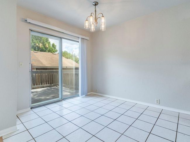 Unfurnished room featuring a chandelier and light tile patterned floors | Image 12