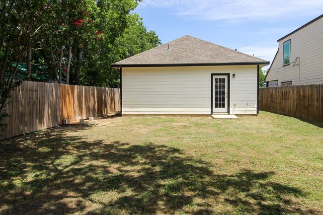 Back of property with a shingled roof and a fenced backyard | Image 20