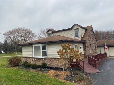 View of property exterior with a wooden deck and a yard | Image 2