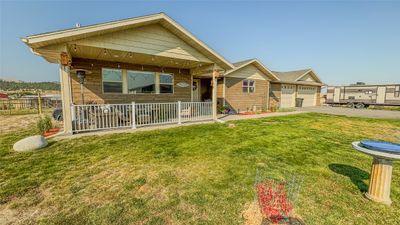 View of front of property with a front yard and a garage | Image 2