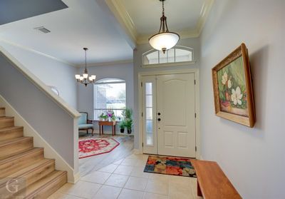 Foyer entrance featuring a notable chandelier, ornamental molding, and light wood-type flooring | Image 3