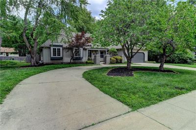 Ranch-style house with a garage and a front yard | Image 3