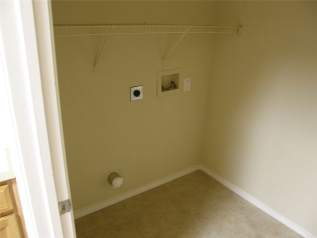 Washroom featuring electric dryer hookup, washer hookup, and light tile patterned floors | Image 8