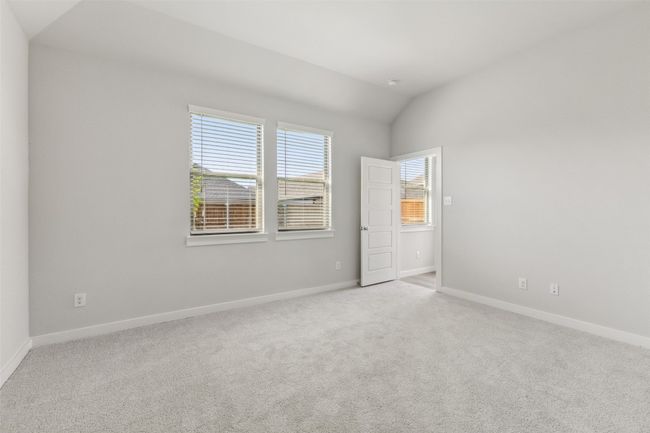 Spare room with carpet flooring, lofted ceiling, and baseboards | Image 11