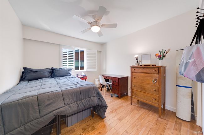 Bedroom featuring light wood-style floors and ceiling fan | Image 25
