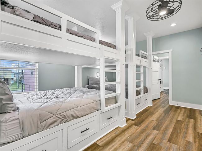 First of two built-in bunk rooms—this one sleeps 8 with custom queen-over-queen bunks, built-in lighting, storage drawers, and direct access to a Jack & Jill style bathroom - making it the perfect setup for kids or large group getaways. | Image 22