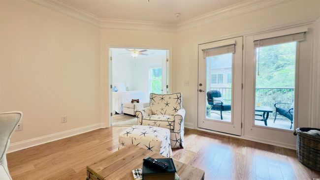 Sitting room with crown molding, wood finished floors, and ceiling fan | Image 31