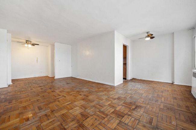 Spare room with ceiling fan and baseboards | Image 6