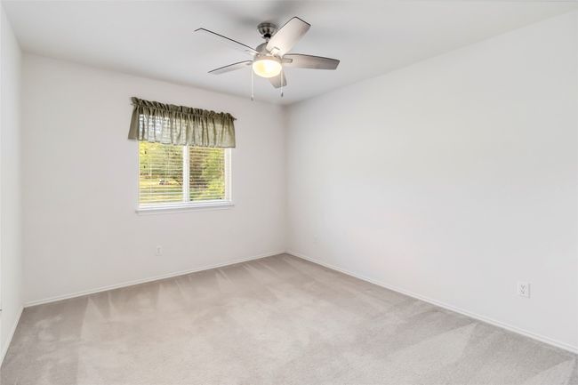Unfurnished room with light colored carpet, a ceiling fan, and baseboards | Image 29