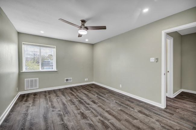 Unfurnished room with dark wood-style flooring, ceiling fan, baseboards, and recessed lighting | Image 19