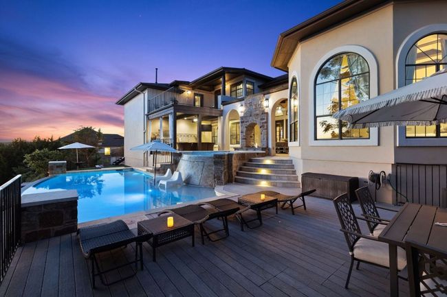 Outdoor pool featuring a wooden deck and outdoor dining area | Image 39