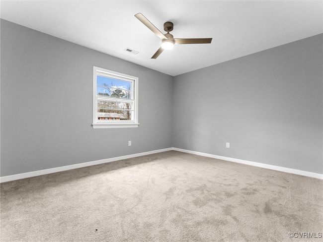 Carpeted spare room with a ceiling fan, visible vents, and baseboards | Image 29