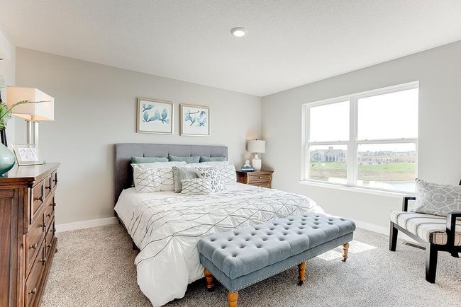 Spacious primary bedroom has a great walk in closet and private bath. Photo of model home, color & options will vary. | Image 14