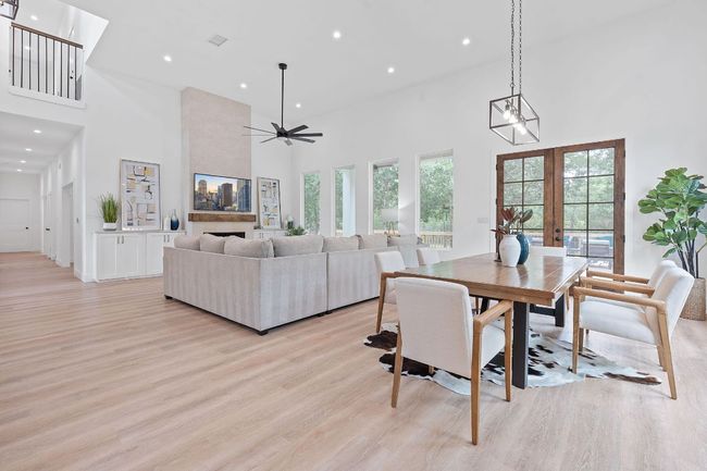 Dining space featuring light wood-type floors, recessed lighting, and a towering ceiling | Image 15