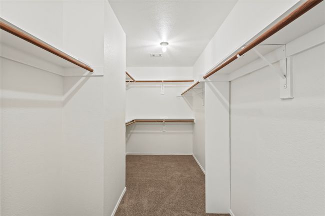 Walk in closet featuring carpet floors | Image 13