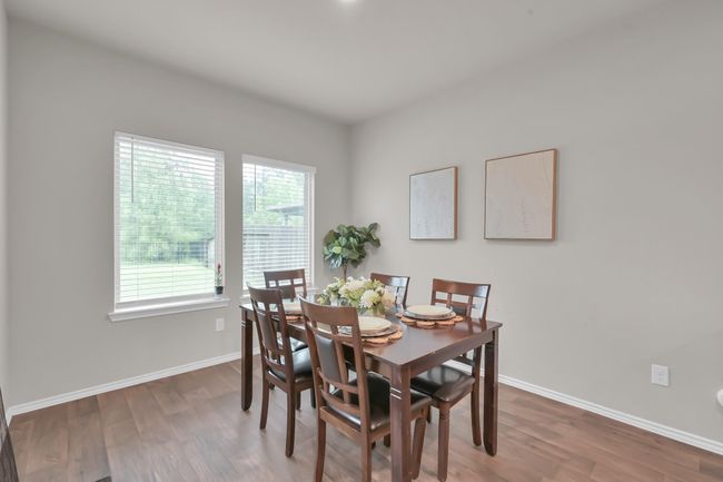 With two large windows pouring in natural light, the dining area feels bright and welcoming. Plenty of space for a larger table and more table settings! | Image 14