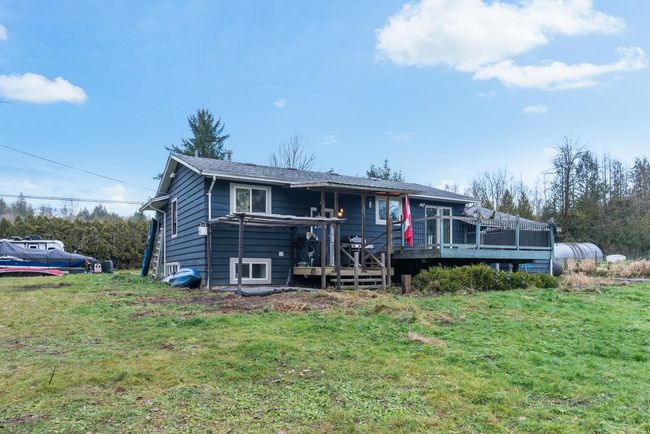 View of front of home featuring a front yard and a wooden deck | Image 10