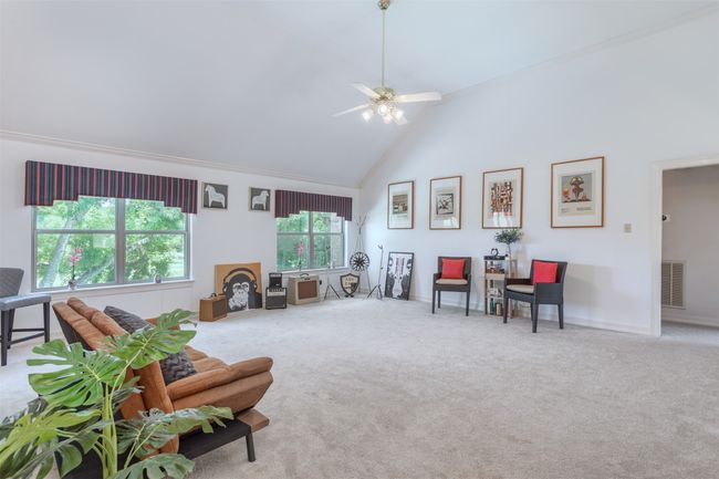 Second level iving area with high vaulted ceiling, carpet, and ceiling fan | Image 21