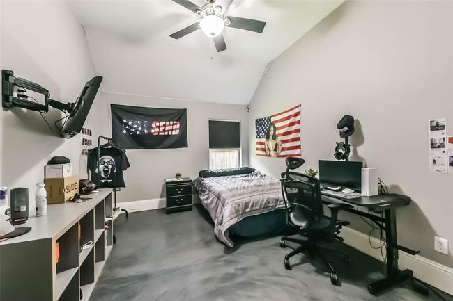 This bedroom has a modern design with neutral walls and dark flooring.The room is well-lit, creating a cozy yet functional space ideal for relaxation and productivity. | Image 25