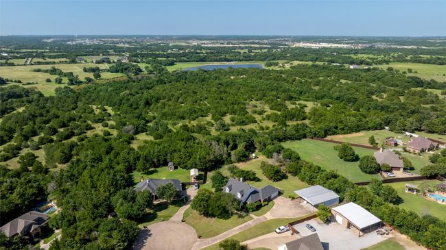 View of property location featuring a large body of water and a heavily wooded area | Image 22