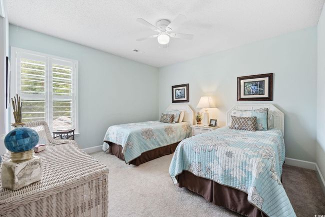Carpeted bedroom featuring a textured ceiling and a ceiling fan | Image 34