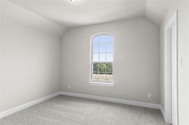 Unfurnished room with vaulted ceiling, light colored carpet, and baseboards | Image 18