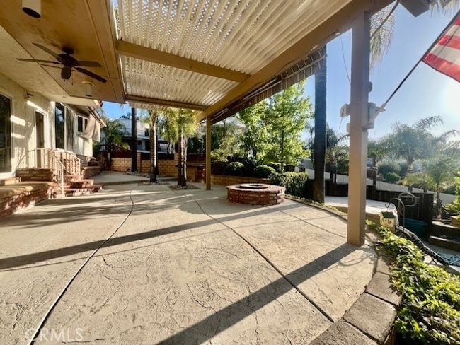 Full view of patio which shows fire pit and dining areas | Image 40