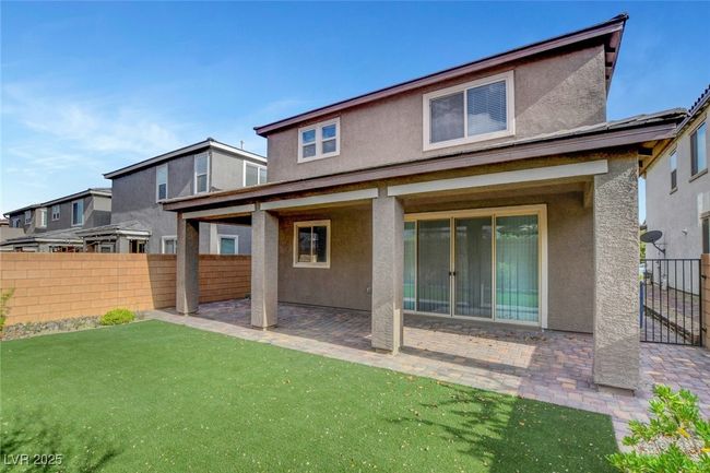 Rear view of property with stucco siding and a patio | Image 50