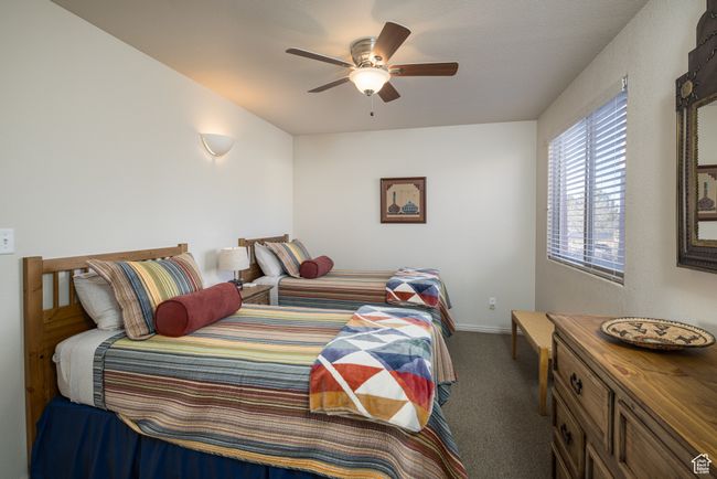 Bedroom featuring dark colored carpet and ceiling fan | Image 28