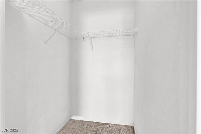 Walk in closet featuring light colored carpet | Image 20