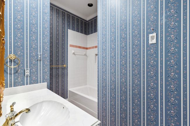 Guest Bath with tub-shower combination and a dreamy walk in closet. | Image 36