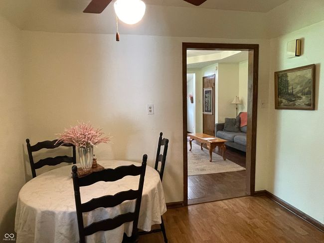 dining area featuring a ceiling fan and wood finished floors | Image 12