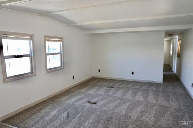 Unfurnished room with carpet floors and baseboards | Image 6