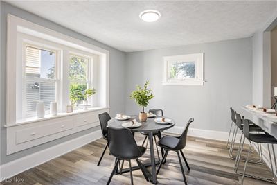 Dining room with a textured ceiling and light hardwood / wood-style flooring | Image 3