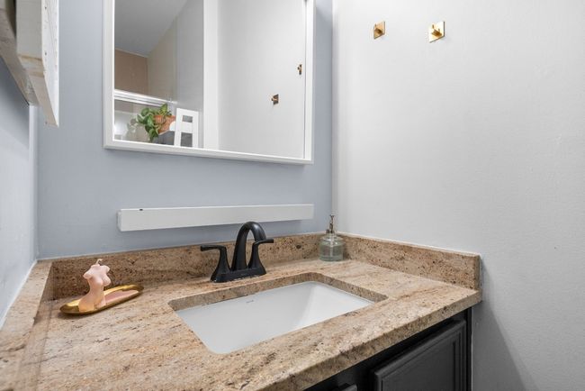 Primary Bathroom with Quartz Countertop Vanity, walk in shower and tile flooring | Image 30