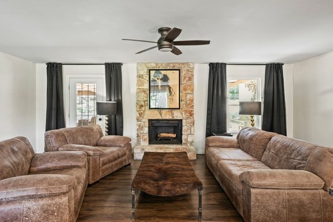 Living room featuring a stone fireplace | Image 7