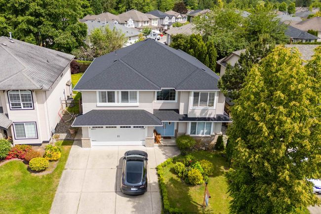 View of front facade featuring roof with shingles, driveway, a residential view, and an attached garage | Image 30