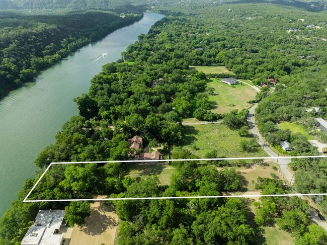 Bird's eye view of a nearby body of water and a heavily wooded area | Image 9