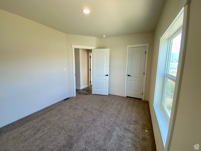 Unfurnished bedroom featuring dark carpet and recessed lighting | Image 15