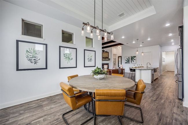 Dining area featuring recessed lighting, dark wood-style flooring, ornamental molding, wooden ceiling, and a tray ceiling | Image 14