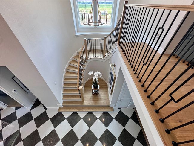 Stairs featuring a high ceiling and baseboards | Image 31