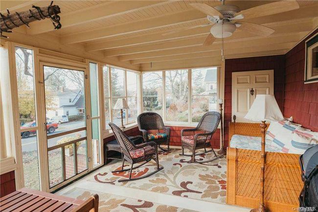 Sunroom with ceiling fan, outdoor lounge area, and beam ceiling | Image 40