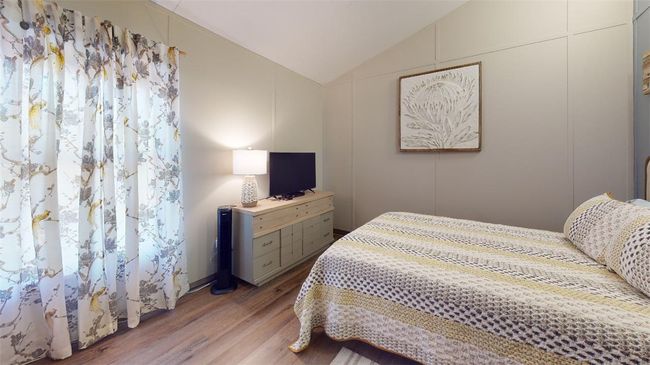 Bedroom featuring vaulted ceiling and wood finished floors | Image 38