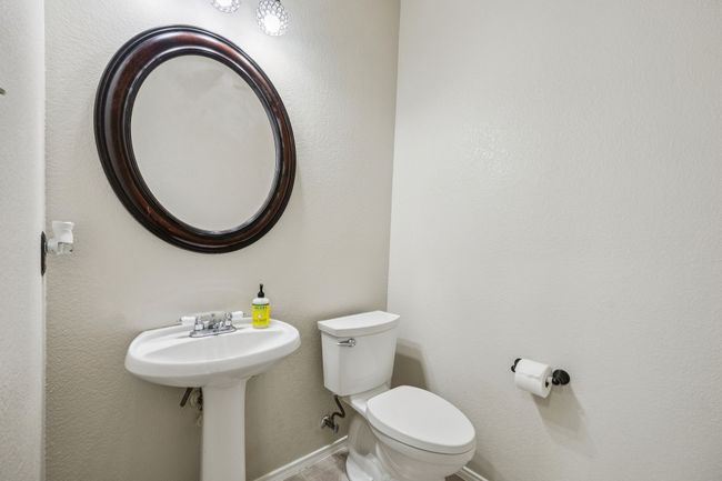 Half bathroom downstairs with toilet and baseboards | Image 6