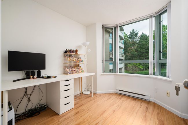 Office area featuring baseboard heating, light wood-style flooring, and plenty of natural light | Image 16