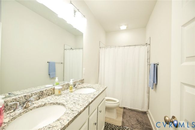 Full bath featuring double vanity and a shower with shower curtain | Image 21