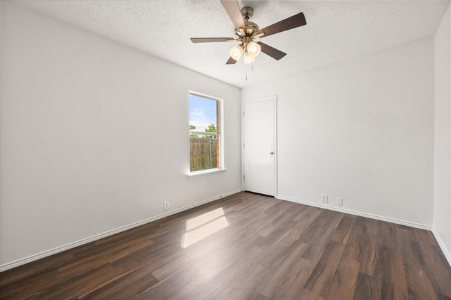 Other Secondary bedroom with dark wood finished floors, ceiling fan, baseboards, and a textured ceiling | Image 23