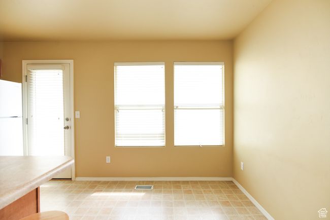 Interior space featuring baseboards and visible vents | Image 16
