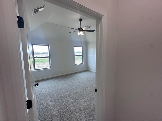 Empty room featuring baseboards, visible vents, carpet flooring, and a ceiling fan | Image 5